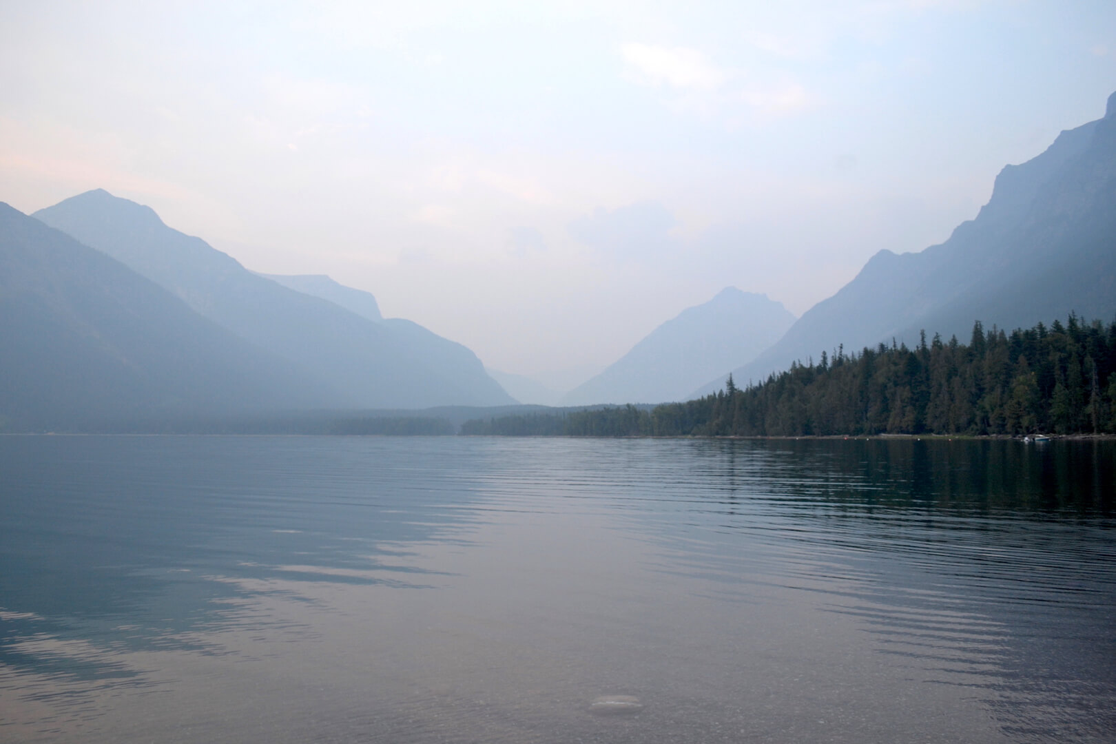 Reflection of a mountain in a gray lake