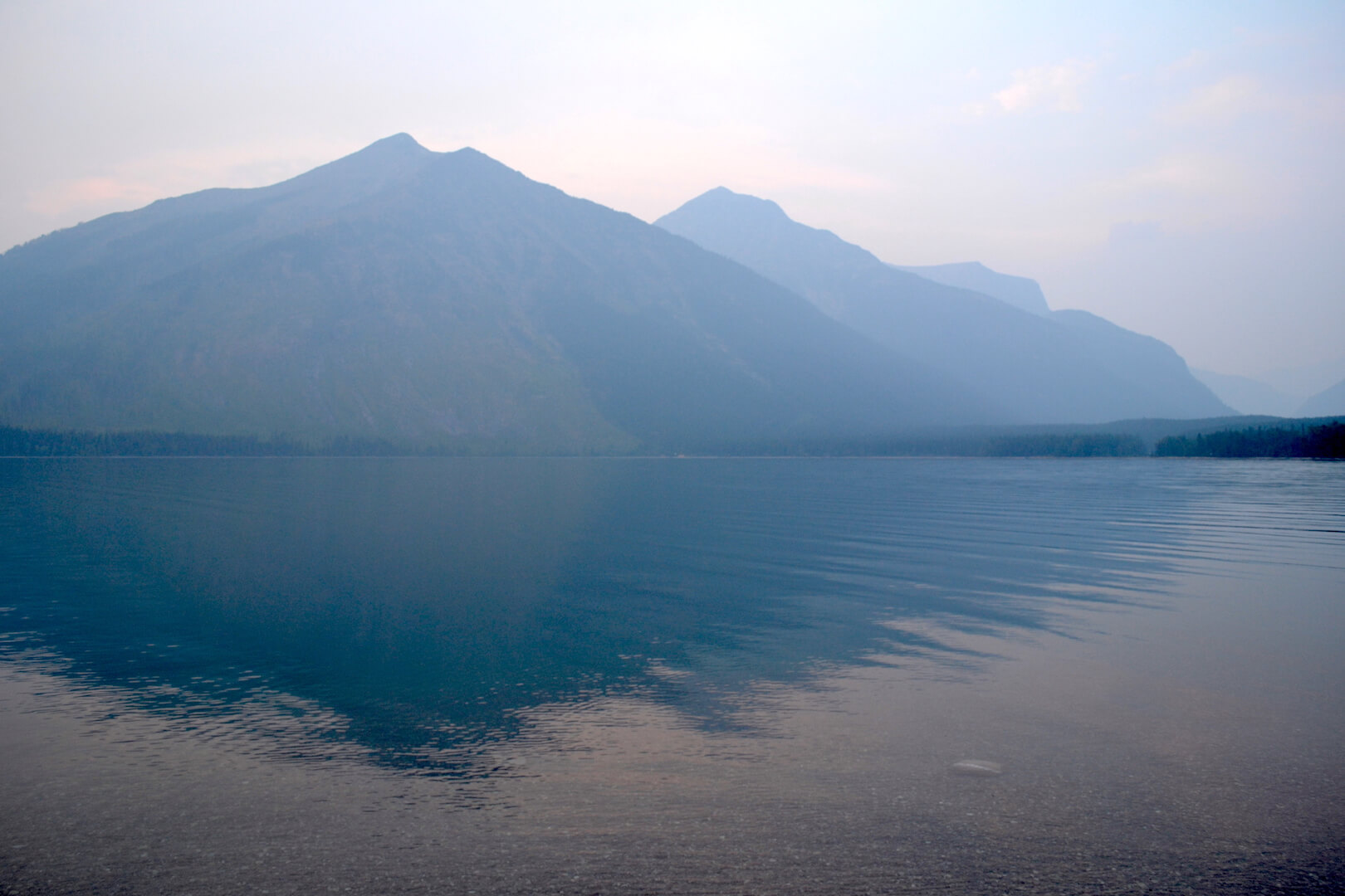 Reflection of a mountain in a gray lake