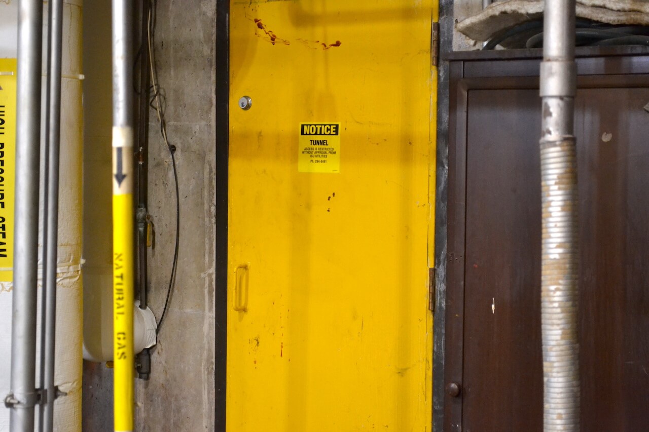 Yellow door with a small notice sign